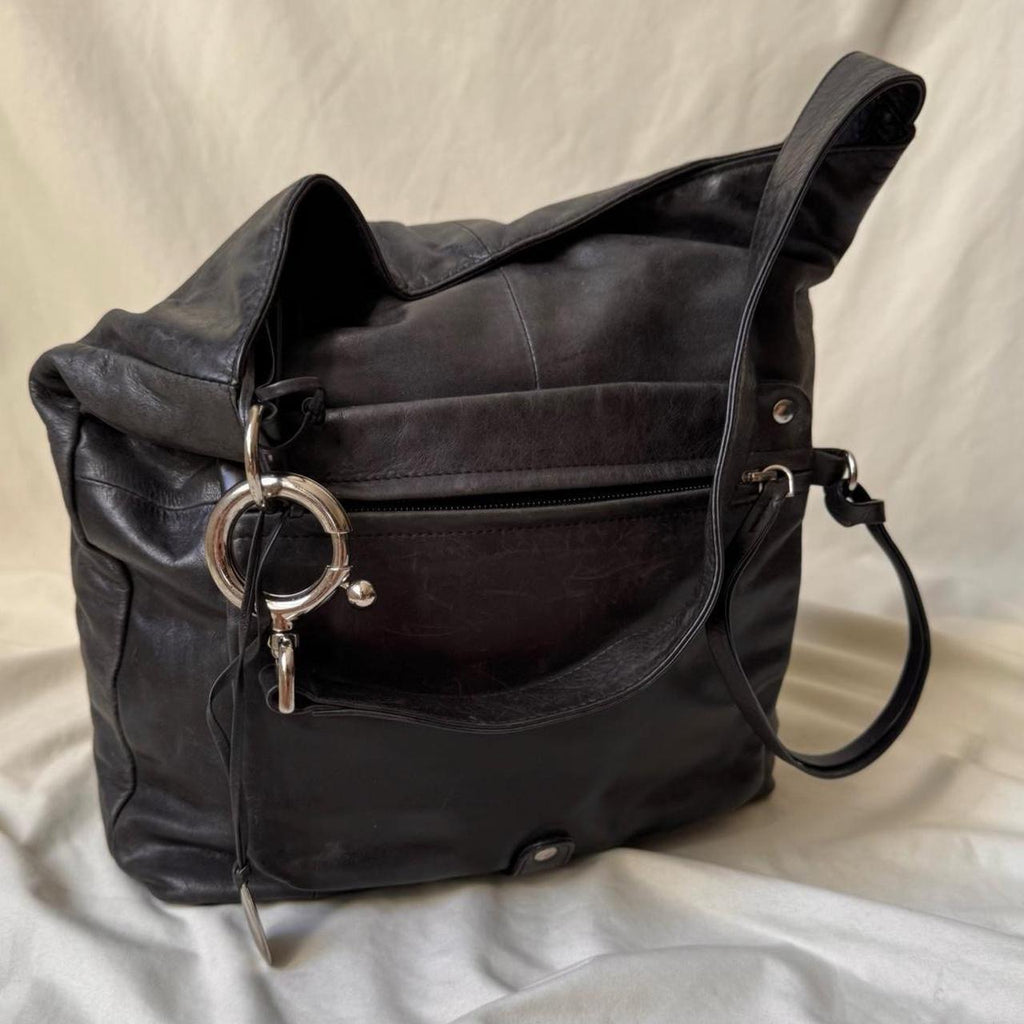 Y2k distressed black leather bag with chunky silver hardware.
