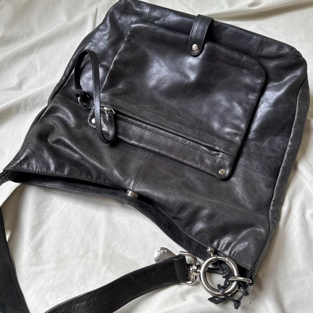 Y2k distressed black leather bag with chunky silver hardware.