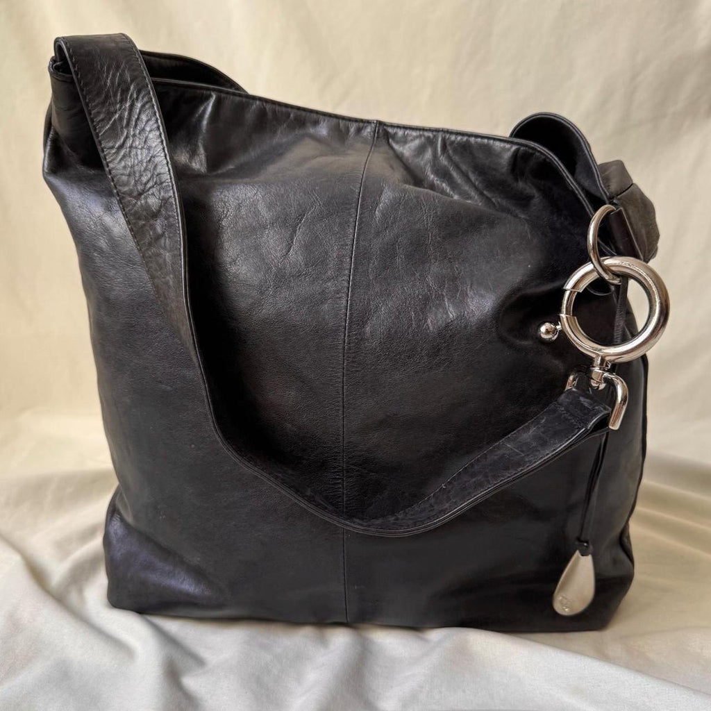 Y2k distressed black leather bag with chunky silver hardware.