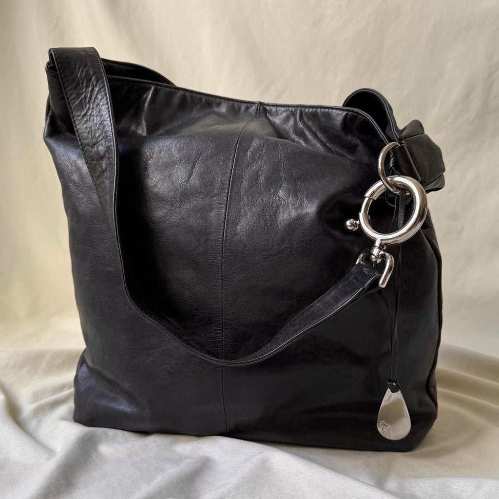 Y2k distressed black leather bag with chunky silver hardware.