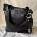 Y2k distressed black leather bag with chunky silver hardware.