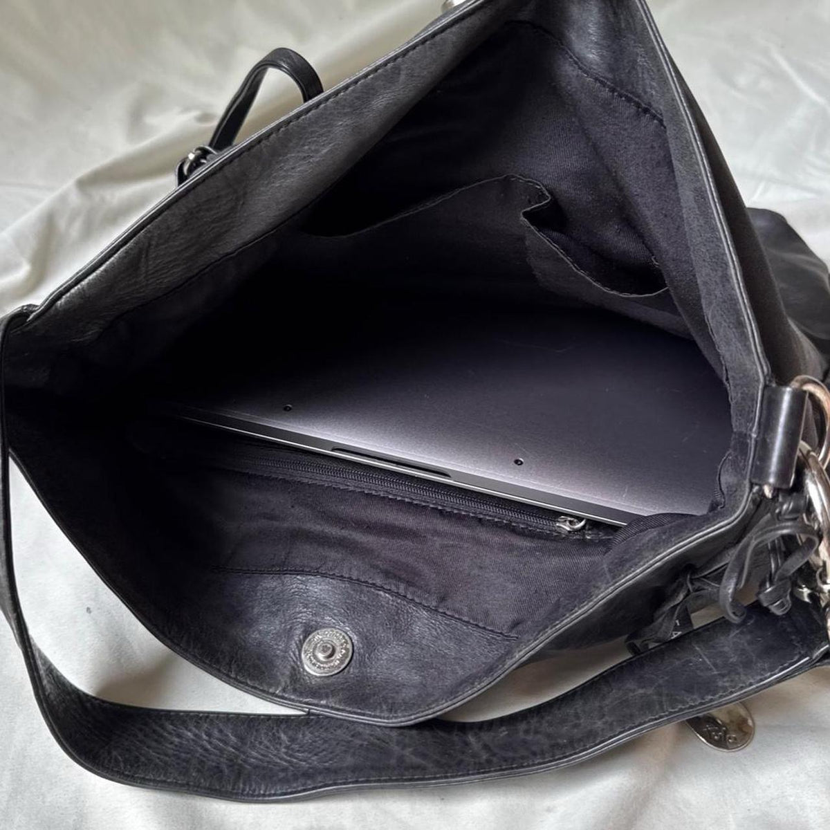 Y2k distressed black leather bag with chunky silver hardware.