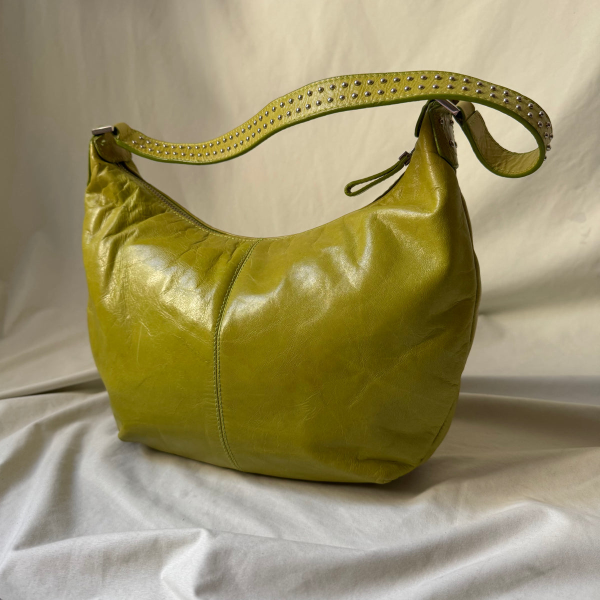Y2K vintage bright lime green leather rounded, curved hobo bag with decorative studs along the strap 
