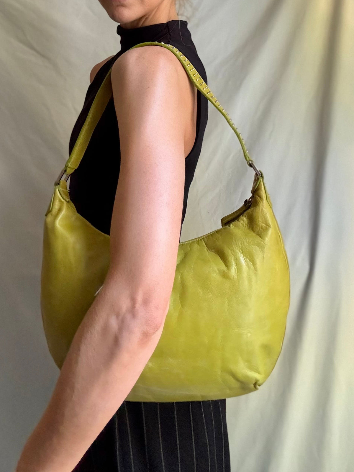 Y2K vintage bright lime green leather rounded, curved hobo bag with decorative studs along the strap 