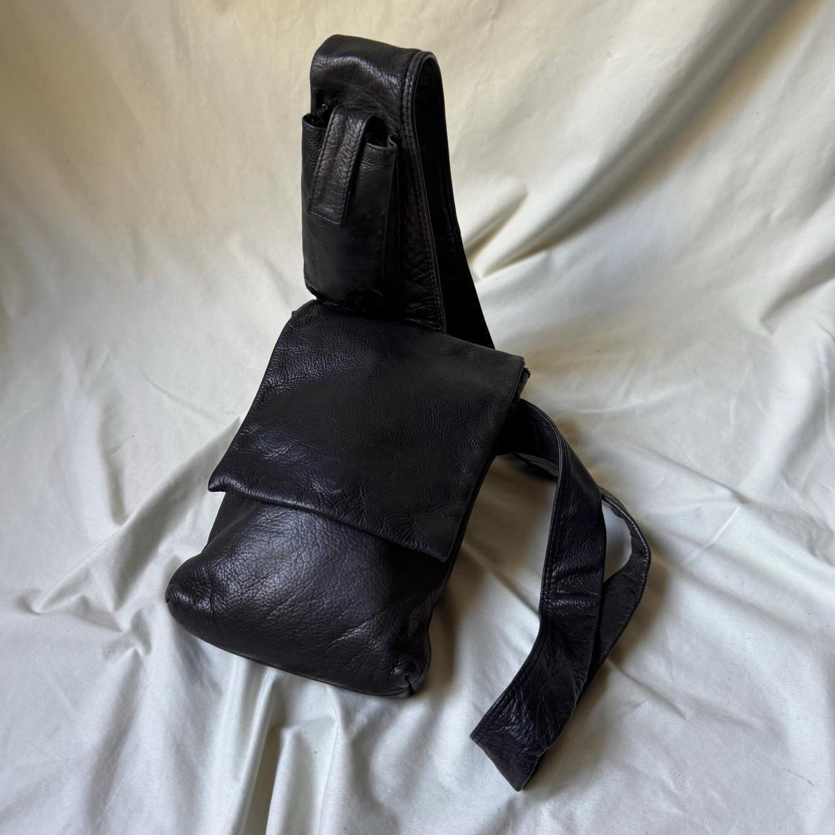 Black leather Y2K crossbody bag with a long strap