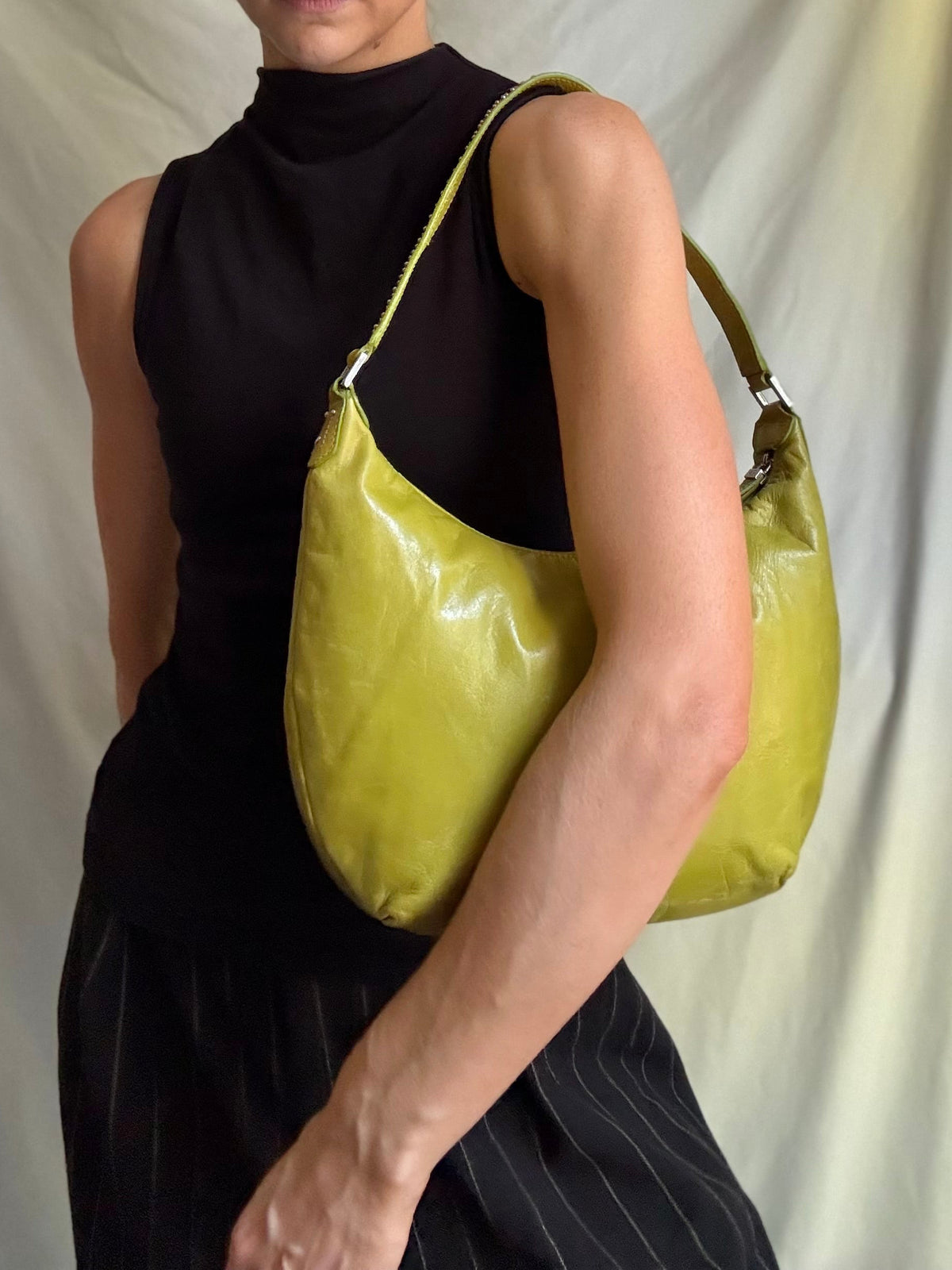 Y2K vintage bright lime green leather rounded, curved hobo bag with decorative studs along the strap 
