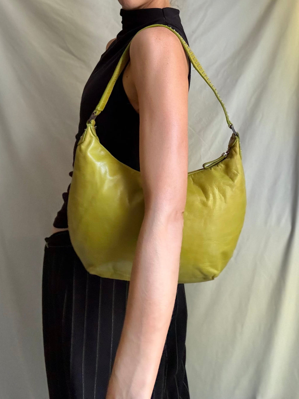 Y2K vintage bright lime green leather rounded, curved hobo bag with decorative studs along the strap 