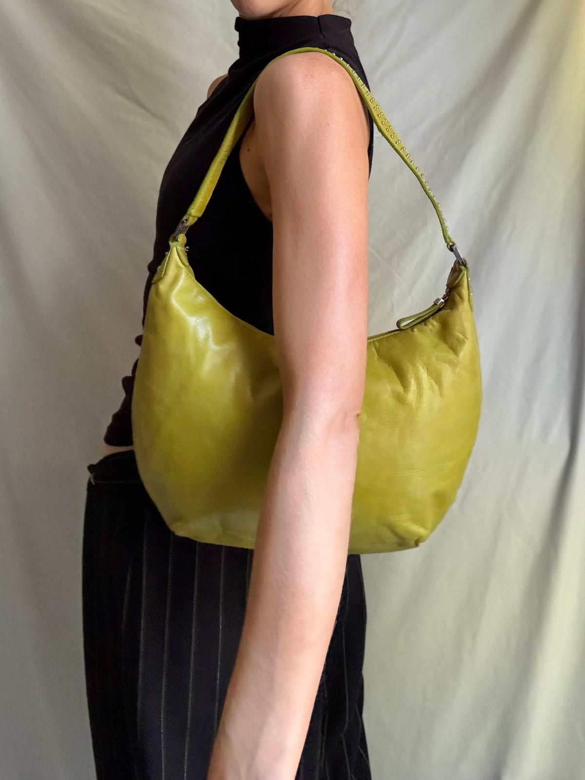Y2K vintage bright lime green leather rounded, curved hobo bag with decorative studs along the strap 