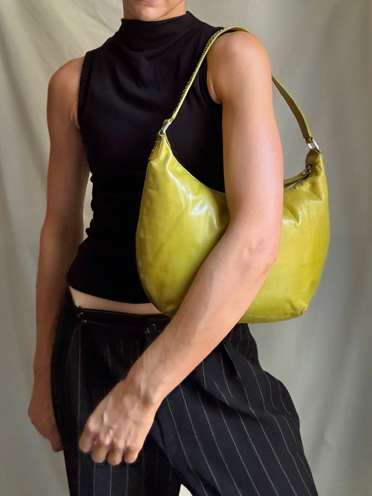 Y2K vintage bright lime green leather rounded, curved hobo bag with decorative studs along the strap 