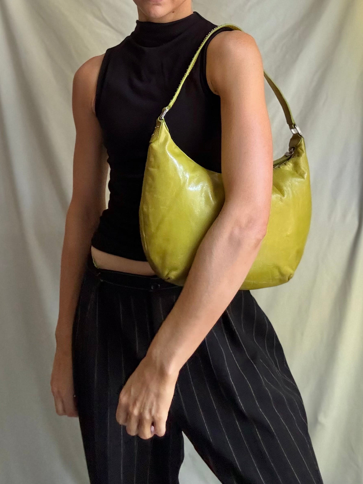 Y2K vintage bright lime green leather rounded, curved hobo bag with decorative studs along the strap 