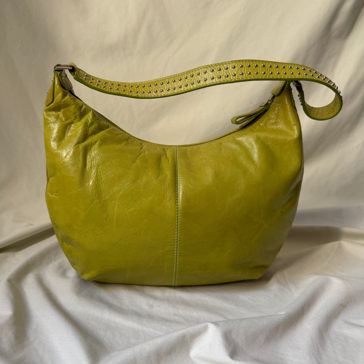Y2K vintage bright lime green leather rounded, curved hobo bag with decorative studs along the strap 